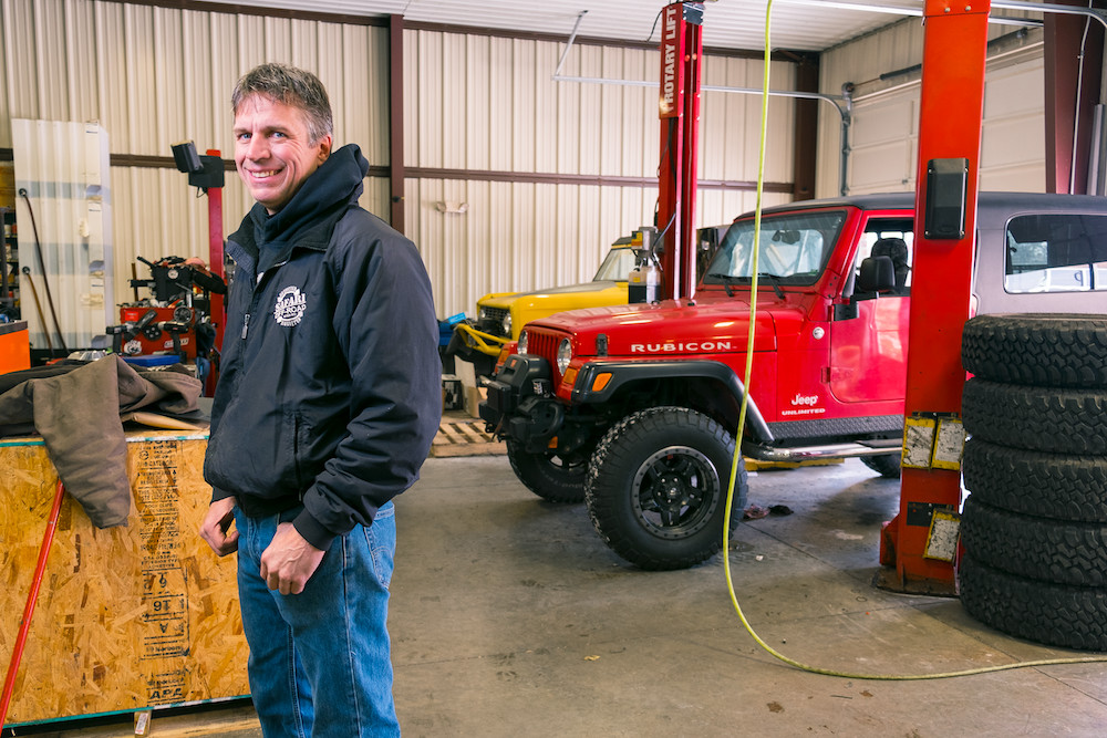 FROM THE ASHES: Shane Ballard stands in his eight-bay shop, for which he reinvested half-a-million dollars in 2010. The team now produces $1 million annually customizing off-road vehicles.