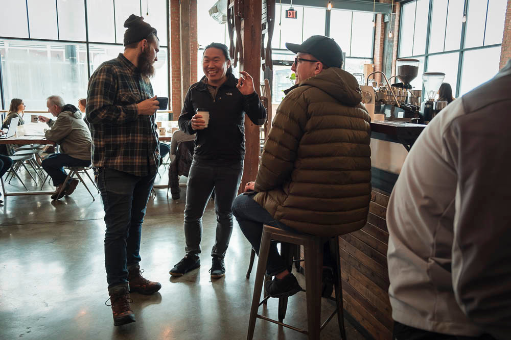 COFFEE CULTURE: Kingdom Coffee & Cycles co-owner Isaac Neale, far left, visits with customers.