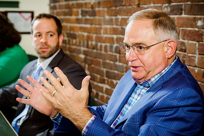 Financial advisers Cody Mendenhall, left, and Ron Penney discuss how not to give into fear.