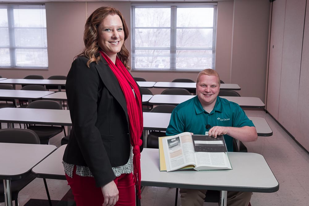PROBLEM SOLVING: Amy Vaughan, chairwoman for Cox College’s master’s in occupational therapy, and student Chris Trout demonstrate a reading assistance product made by Trout.