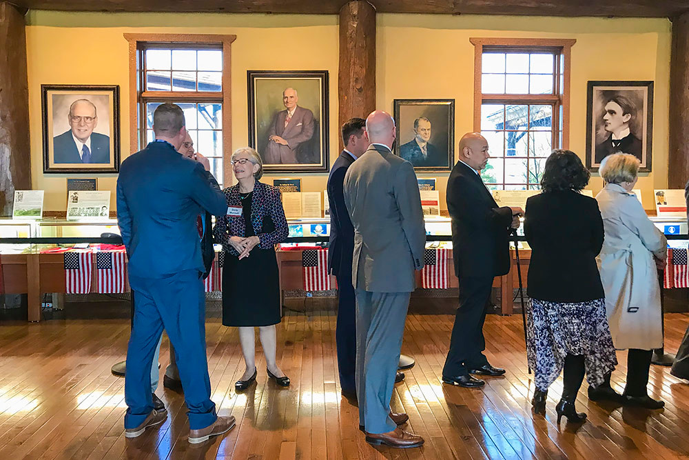 Before the convocation, attendees pass through the college’s Ralph Foster Museum in line to meet Forbes for a quick picture.