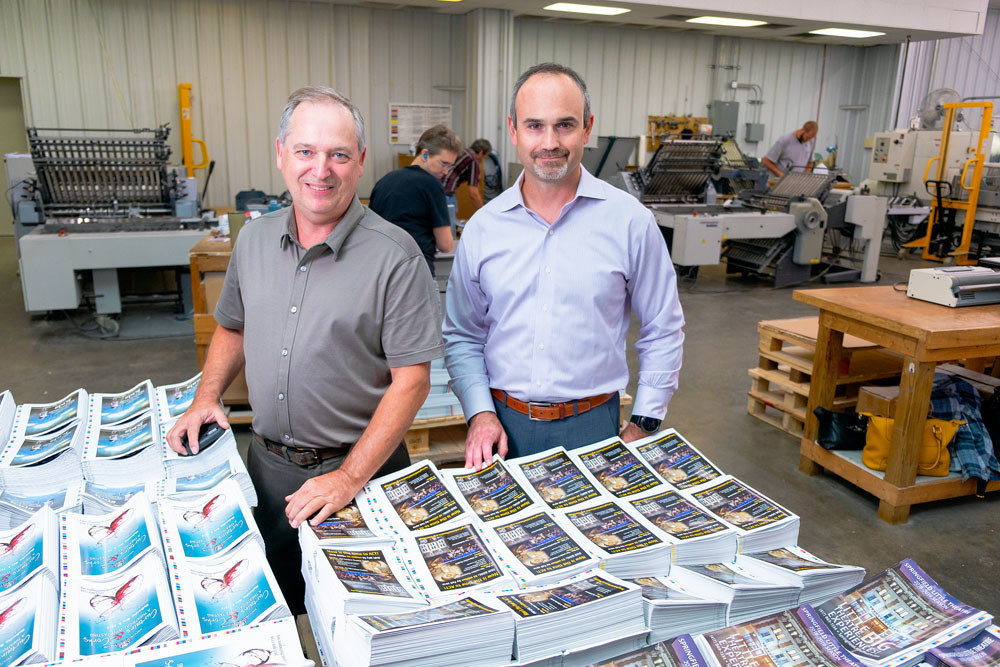 JOINING FORCES: With the purchase of Robert McCann’s company, Color-Graphic CEO Grant Johnson, right, leads the combined commercial printer.