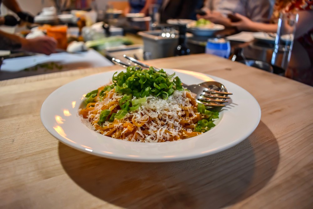 A heaping bowl of spicy Korean buttered noodles are on the menu at Progress. Fresh ramen noodles are tossed in Korean “buffalo sauce” and served with parmesan cheese, sesame seeds and scallions.