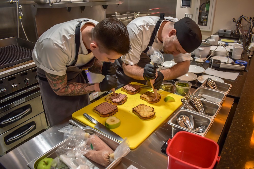 Chefs Daniel Ernce and Bryan Veregge prepare chicken toast, a favorite of co-owner Ernce.