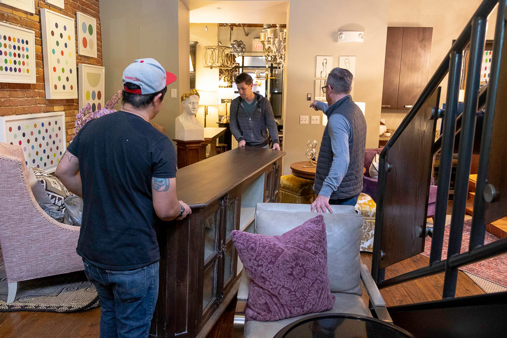 Obelisk Home co-owner Nathan Taylor directs employees as they move furniture onto the sales floor.
