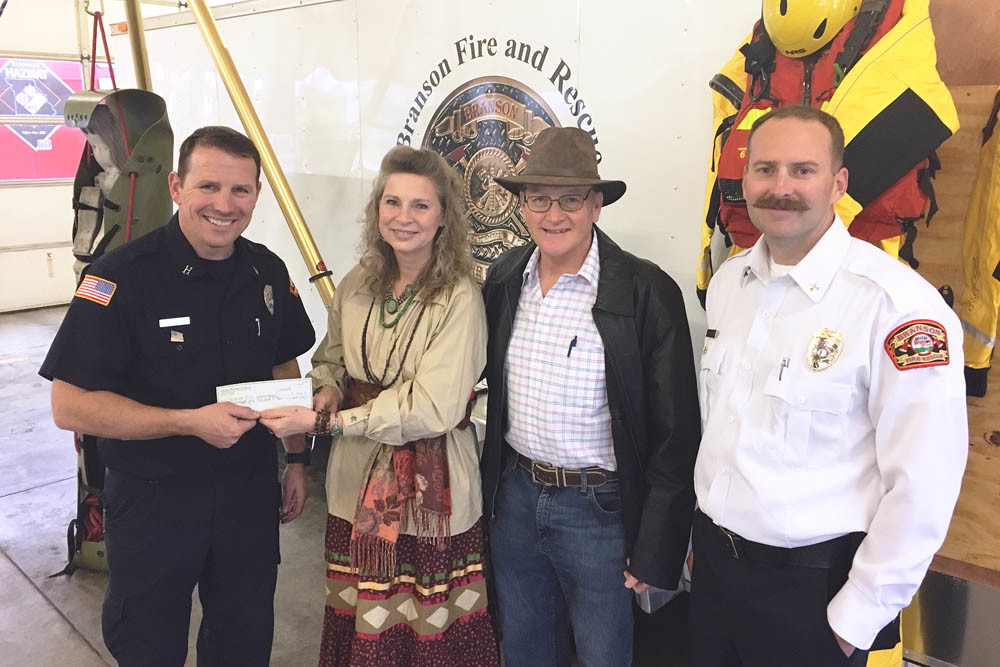 Firefighter Safety
Healing Tree Health Club owner Joy Watson, center, and her husband Tom on Dec. 14 present a $1,500 donation to Branson Fire Department Cpt. Jason Bruck, left, and Battalion Chief Josh Boehm, right. The money is earmarked for firefighter safety improvement purchases and brings the Watsons’ donation total to $5,000 over four years.