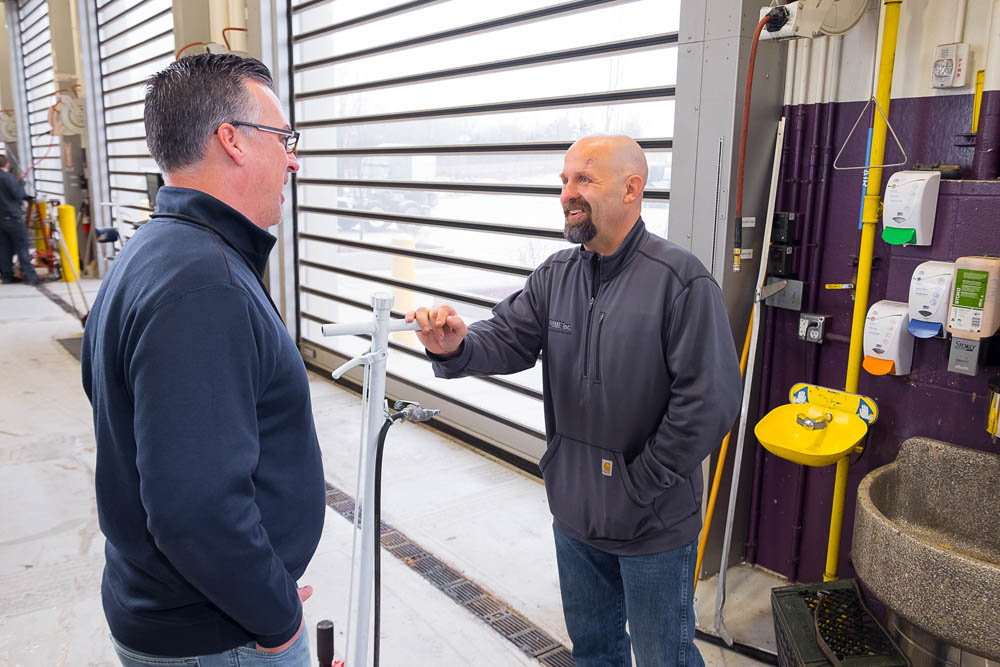 Fleet Maintenance Director Kevin Bergman, left, chatting with plaza foreman Vernon Embree, oversees 600 associates in 10 shops for Prime.