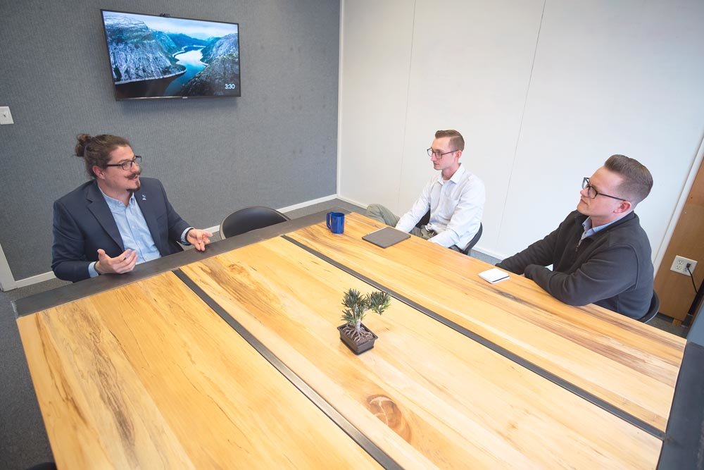 From left, Omer Onder shares his personal and business background during an initial meeting with Longitude’s Dustin Myers and Jeremy Wells.