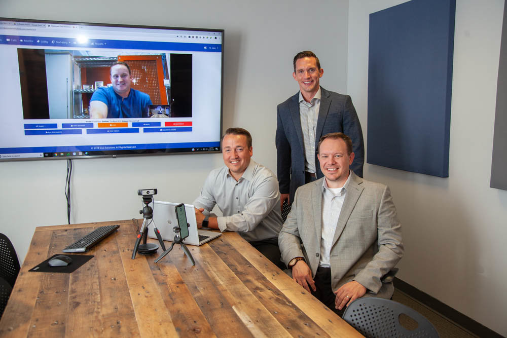THINK VERTICAL: The next step for the Invo Solutions team, James Dennis, on screen, and from left, Derek Williams, Jake Martin and Gary Kirk, is to implement their software in banks across the country. They also plan to develop software for insurance companies.