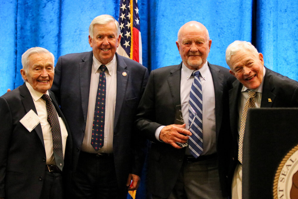 Jack Herschend, Gov. Mike Parson, Peter Herschend and former U.S. Sen. Kit Bond celebrate the recognition during a June 15 event.
