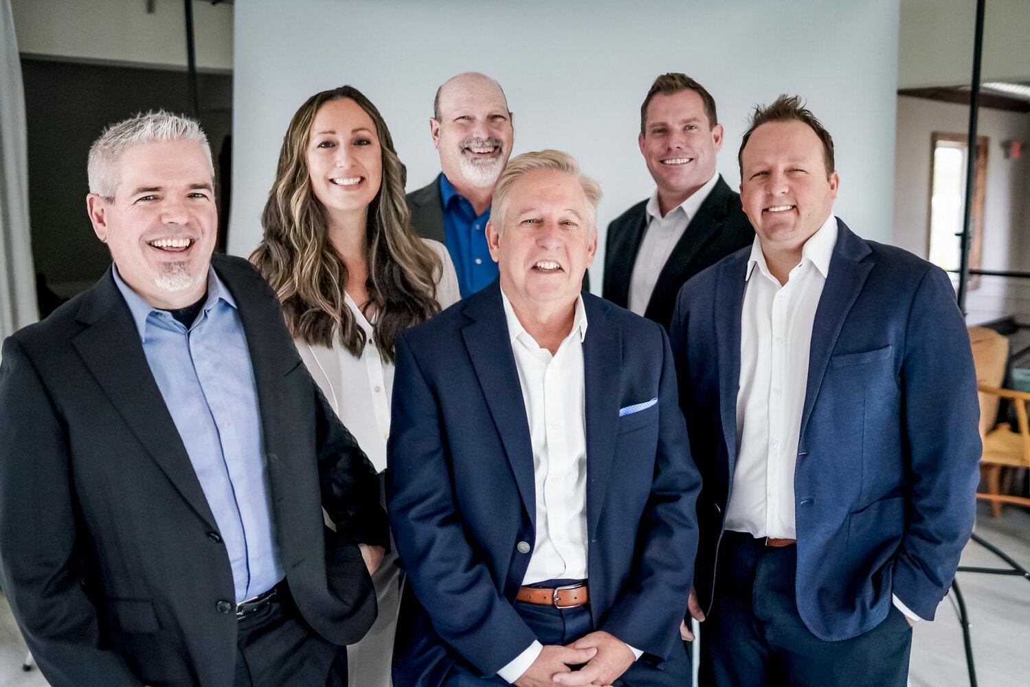 Founder Michael Sapp, third from right, has promoted Brad McKenzie, Kristi Beattie, Stephen Telscher, John McNabb and Ben Sapp.