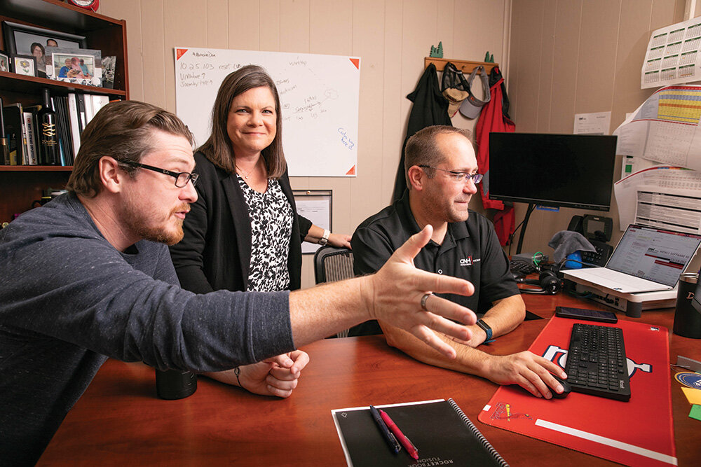 JUGGLING ACT: As information technology project manager for CNH Reman, Kim Roberts coordinates a project with team members Matthew Nowicki, left, and Dan Watson.